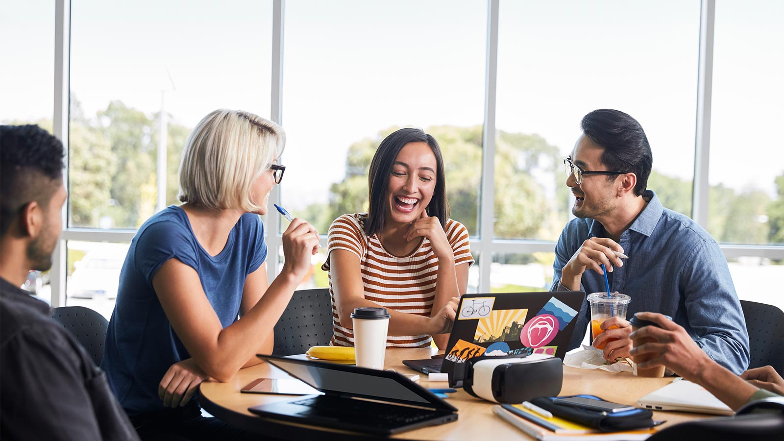 three person having a good time working